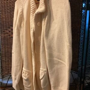 Beautiful sweater with fitted back, sculpted pockets.